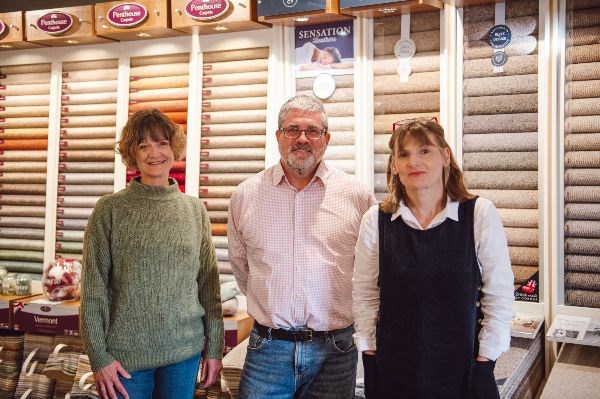 three team members stood together